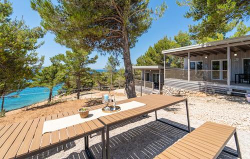 a picnic table on a deck in front of a house at Mobile home Clara in Drage