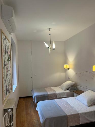 a bedroom with two beds and a ceiling fan at Casa Balcones in Sahagún