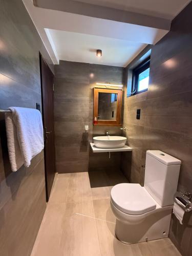 a bathroom with a toilet and a sink at Ranmin Lake Weerawila in Weerawila