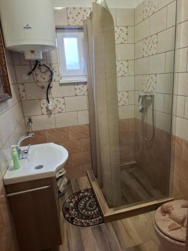 a bathroom with a shower and a sink at Juci Home Apartman in Vonyarcvashegy