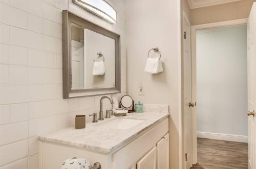a white bathroom with a sink and a mirror at 10 A, One Bedroom Condo in Destin