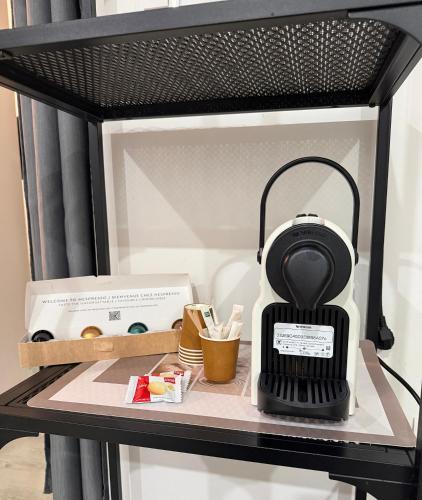 a black and white blender sitting on a shelf at Geneve Gaillard studio in Gaillard
