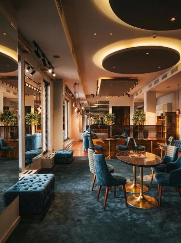 a lobby with tables and chairs and a bar at Il Decameron Luxury Design Hotel in Odesa
