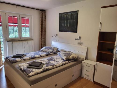 a bedroom with a bed and a dresser at Risika Apartmani in Risika