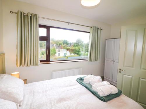 a bedroom with a bed with towels on it at Shamrock House in Killorglin
