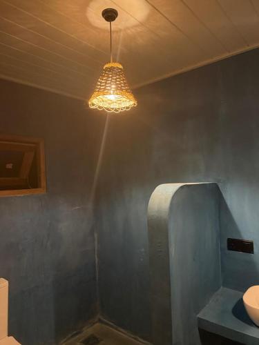 a light hanging from a ceiling in a room at Sea Station in Habaraduwa Central