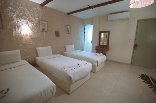 a hotel room with two beds and a mirror at Voyage On The Spot in Cairo