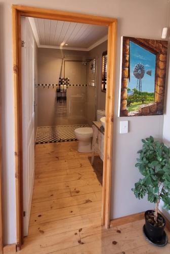 a bathroom with a shower and a toilet in a room at The Lekker Plek - Private country cottage in Zuurbraak