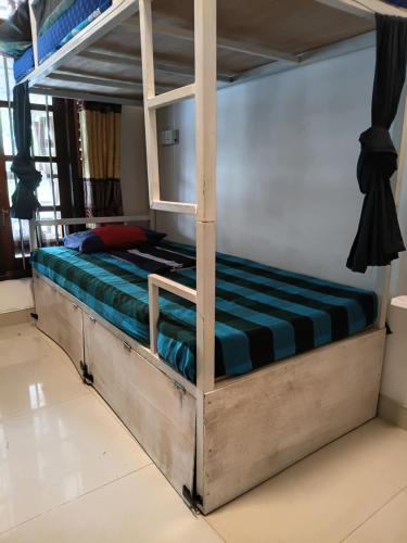 a bed in a room with a bunk bed at Social Stay Hostal in Ahangama