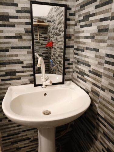 a white sink in a bathroom with a mirror at Social Stay Hostal in Ahangama