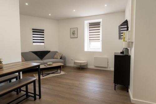a living room with a couch and a table at 201- Appartement- proche gare in Saint-Brieuc