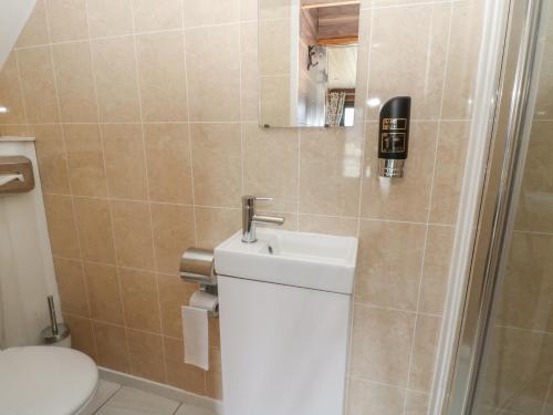 a bathroom with a toilet and a sink at Glamping Tri Pod 2 - Gower in Swansea