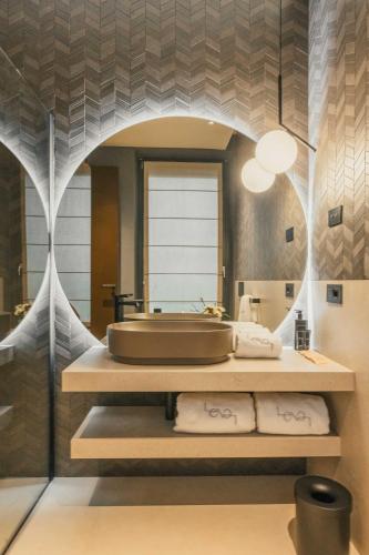 a bathroom with a sink and a bath tub at Lenel Boutique Room - La Locanda in Brescia