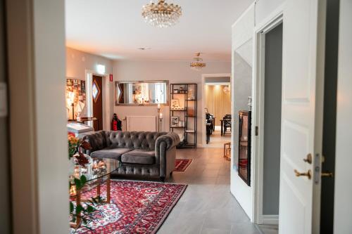 a living room with a couch and a rug at Villa Granliden in Ludvigsborg