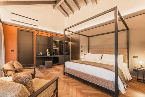 a bedroom with a canopy bed and a chair at Lenel Boutique Room - La Locanda in Brescia