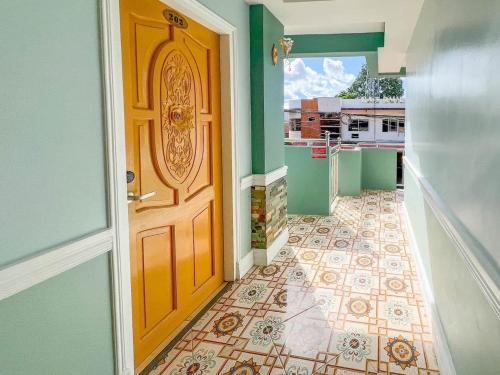 a door in a hallway with a tile floor at Filipinas Hostel in Dipolog