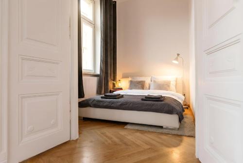 a bedroom with a large bed in a white room at Apartament na Granicy 6 in Cieszyn