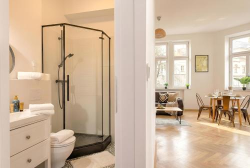 a bathroom with a shower with a toilet and a table at Apartament na Granicy 6 in Cieszyn