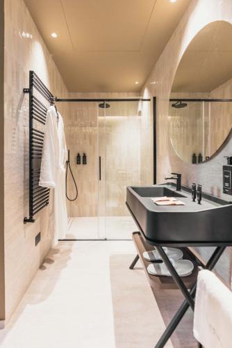 a bathroom with a sink and a shower at Lenel Boutique Room - La Foresteria in Brescia