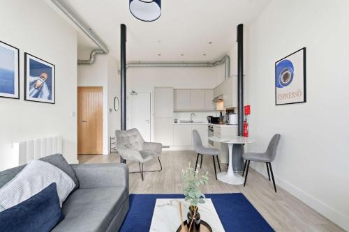 a living room with a couch and a table at Characterful 1 Bed Apartment in Central Nottingham in Nottingham