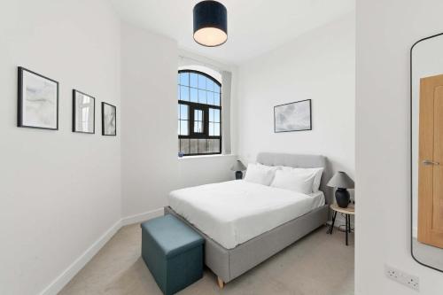 a white bedroom with a bed and a window at Characterful 1 Bed Apartment in Central Nottingham in Nottingham