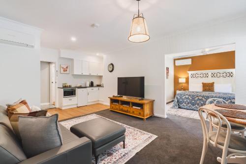 a living room with a couch and a bed at Rosewood Guesthouse in Margaret River Town