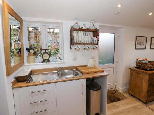a kitchen with a sink and a counter at Tucked Away in Evesham