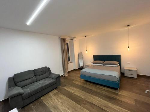 a bedroom with a bed and a couch at Garibaldi 105 in Castrovillari
