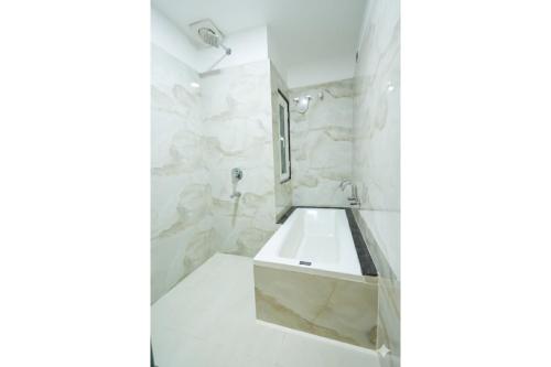 a bathroom with a sink and a shower at Hotel Anmol One in Indore