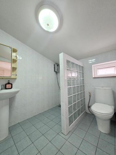 a bathroom with a toilet and a sink at Townhome 49 in Ban Nong Pru