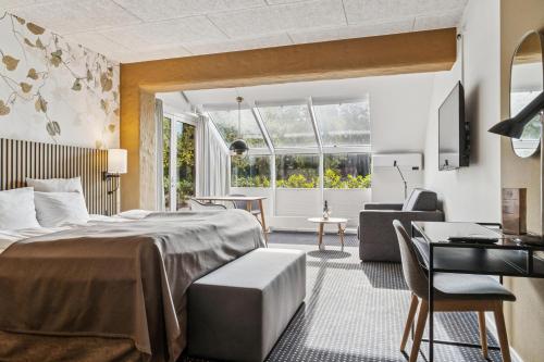 En eller flere senge i et værelse på Hotel Dalgas, BW Signature Collection