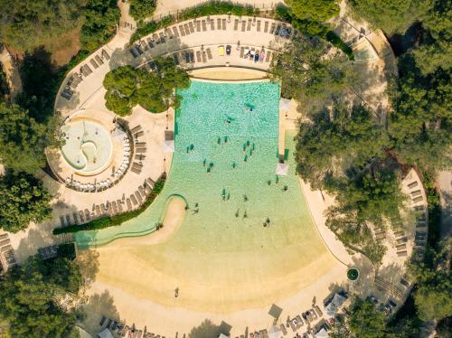 an overhead view of a swimming pool with people in it at Village Pierre & Vacances Pont Royal en Provence in Mallemort
