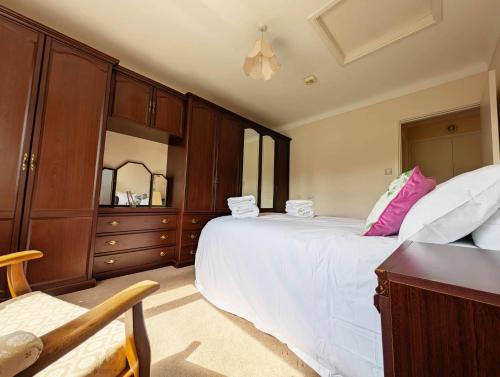 a bedroom with two beds and a dresser at Roslyn in Romsey