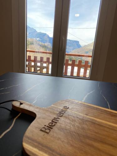 a wooden surfboard sitting on a table next to a window at Sous l'Alpette en Chartreuse in Saint-Pierre-dʼEntremont