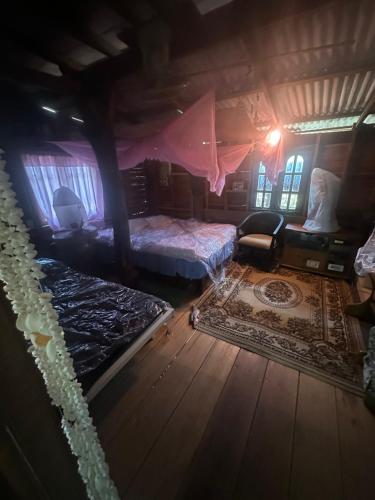 a bedroom with a bed and a rug in a room at Tan Homestay in Ko Lanta