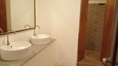 a bathroom with two sinks and a mirror at Palawan Coliving - Palawan Coworking in Puerto Princesa City