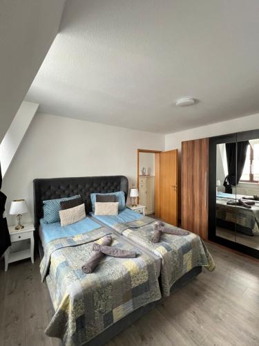 a bedroom with a large bed with teddy bears on it at Villa Louis Hirsch in Gera