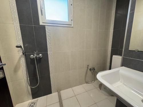 a bathroom with a shower and a sink at Le Charbon Mystique in Sfax