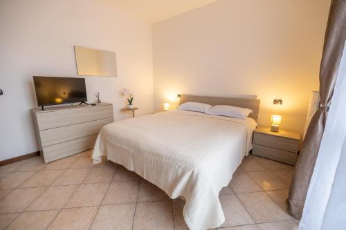 a bedroom with a bed and a flat screen tv at Casa Alexandra in Pantigliate