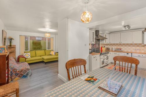 a kitchen and living room with a table and chairs at Rabbit Haven- Near Bicester Village & Town - ShireStays in Bicester