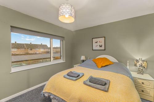 a bedroom with a bed with two towels on it at Rabbit Haven- Near Bicester Village & Town - ShireStays in Bicester