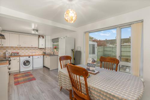 a kitchen and dining room with a table and a table and chairs at Rabbit Haven- Near Bicester Village & Town - ShireStays in Bicester