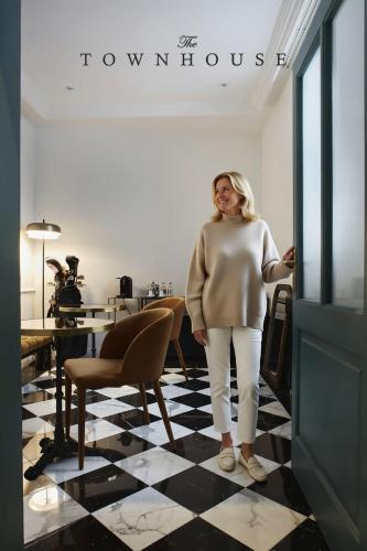 a woman standing next to a door in a room at The Townhouse in Udine