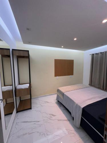 a bedroom with a bed and a window in it at JB condominio b in Maceió
