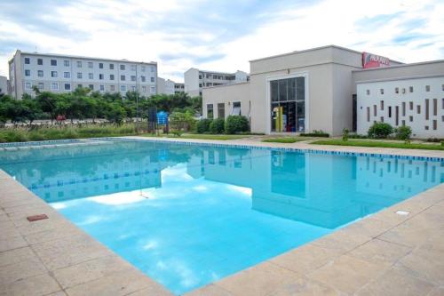 a large swimming pool in front of a building at 1brm,2bdrm,3bdrm Palm Ridge Heavens Vipingo in Kilifi