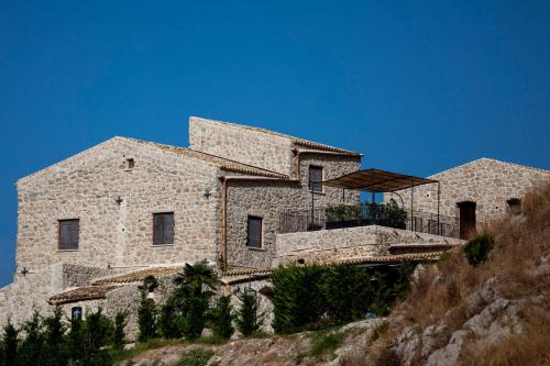 a large stone house on top of a hill at Masseria Agnello in Realmonte