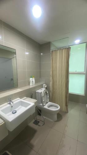 a bathroom with a sink and a toilet and a mirror at JY Vacation Home New & Modern Suite Infinity pool-Sutera Avenue in Kota Kinabalu