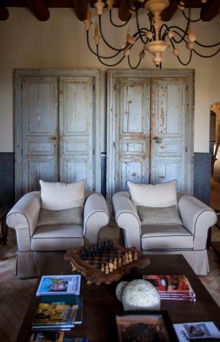 a living room with two couches and a table at Masseria Agnello in Realmonte