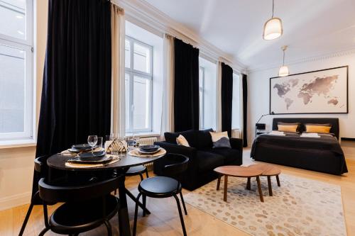 a living room with a table and a couch at Luxury Central Riga Studio, Raina Nams in Riga