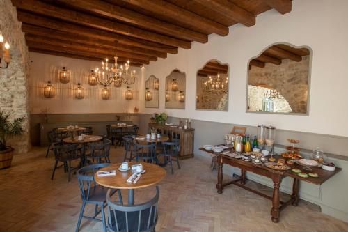 a restaurant with tables and chairs in a room at Masseria Agnello in Realmonte
